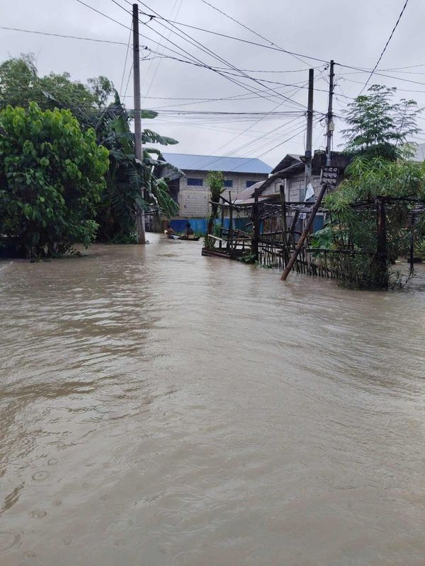 Families navigating flooded areas